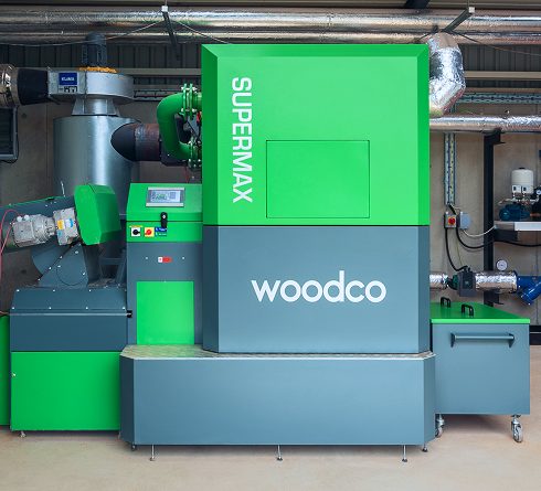 A wood boiler system in operation, efficiently burning wood fuel to provide renewable heating for residential or commercial use