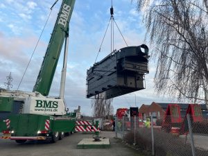installing an industrial chip boiler, ensuring proper connections to the fuel feed system and pipework for optimal heating