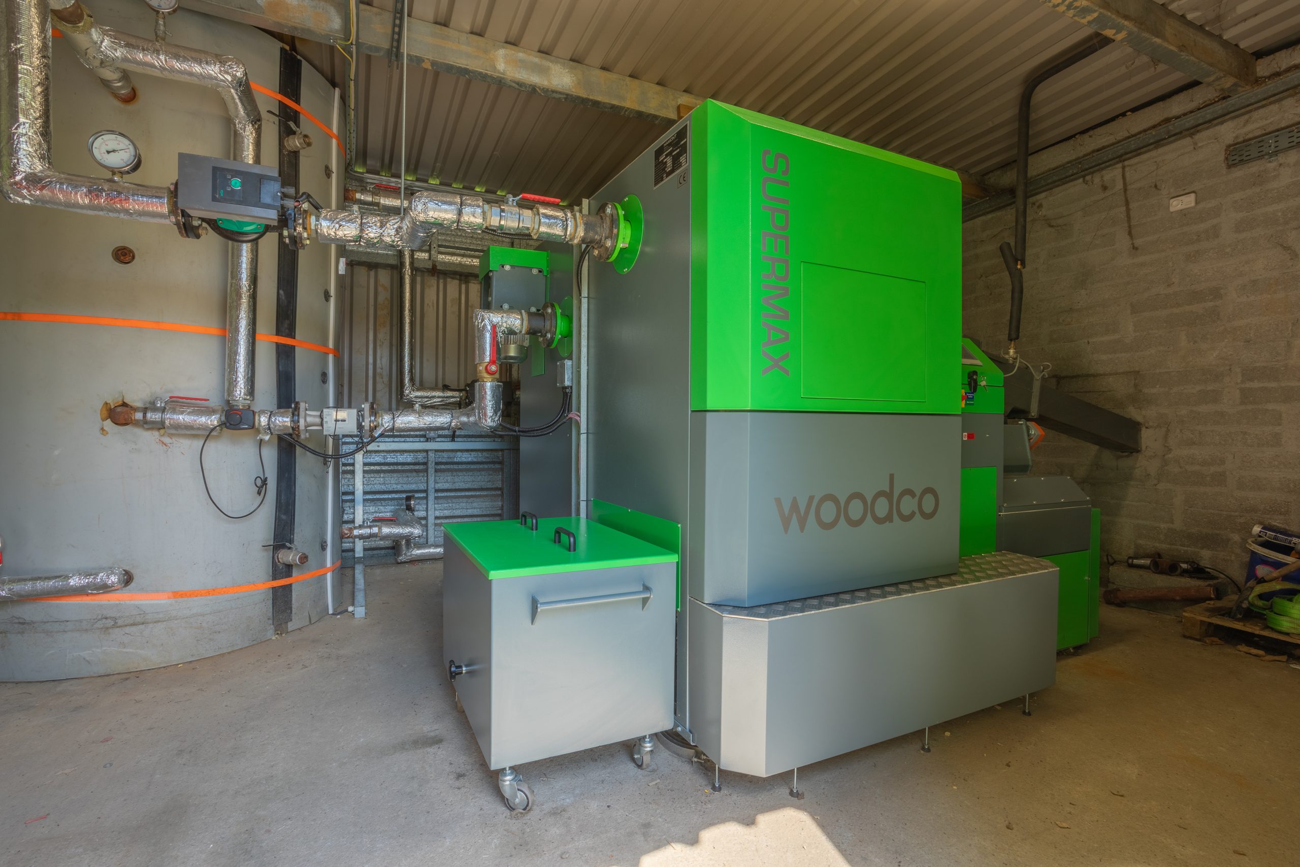 Woodco biomass boiler in operation, feeding renewable heat into the heating system of a building
