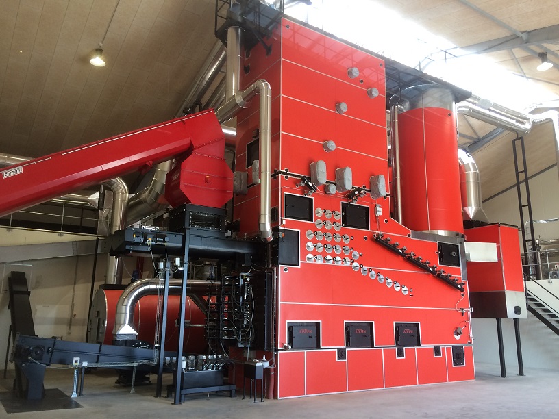 Industrial chip boiler using wood chips as renewable fuel to provide sustainable heating for a large-scale facility