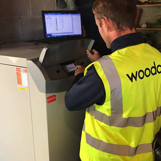 Biomass engineer inspecting and maintaining a biomass boiler system, ensuring efficient operation and optimal performance of renewable energy equipment