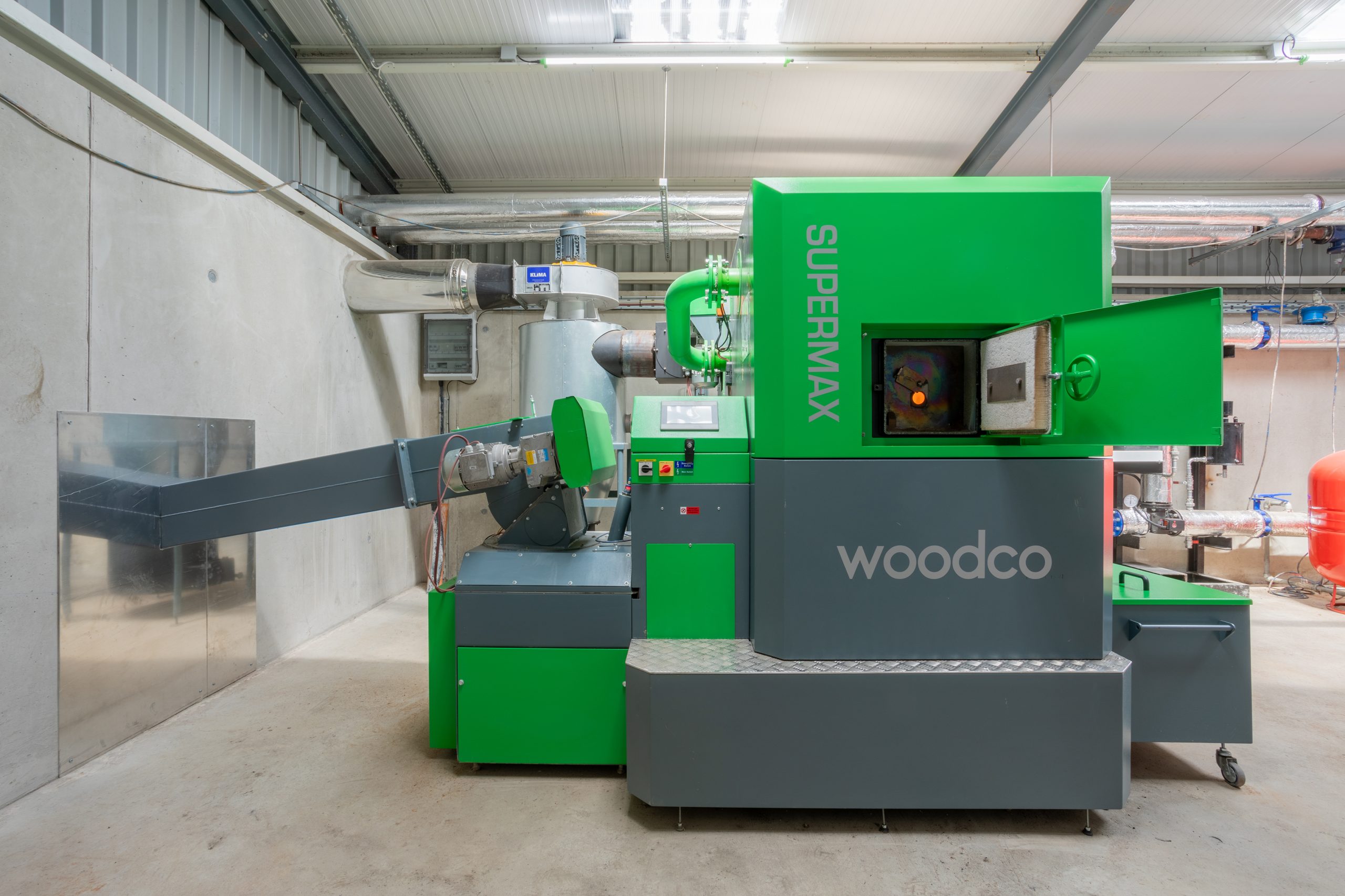 Woodco biomass boiler unit designed for efficient, eco-friendly heating using renewable fuels like wood pellets or chips