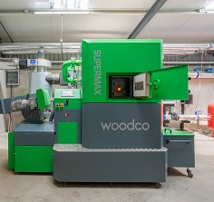 Woodco biomass boiler unit with touchscreen control panel and feed auger connection