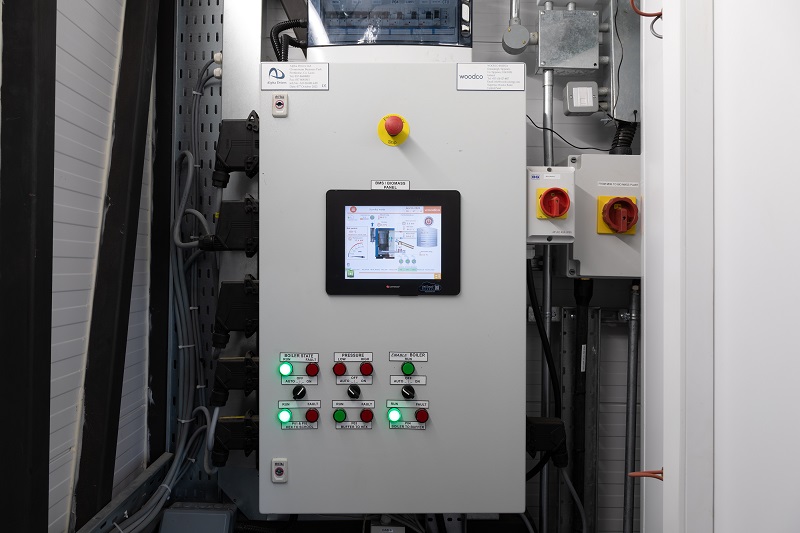 Close-up view of the iGen Max controller’s digital display showing system parameters like temperature, flow rate, and energy usage