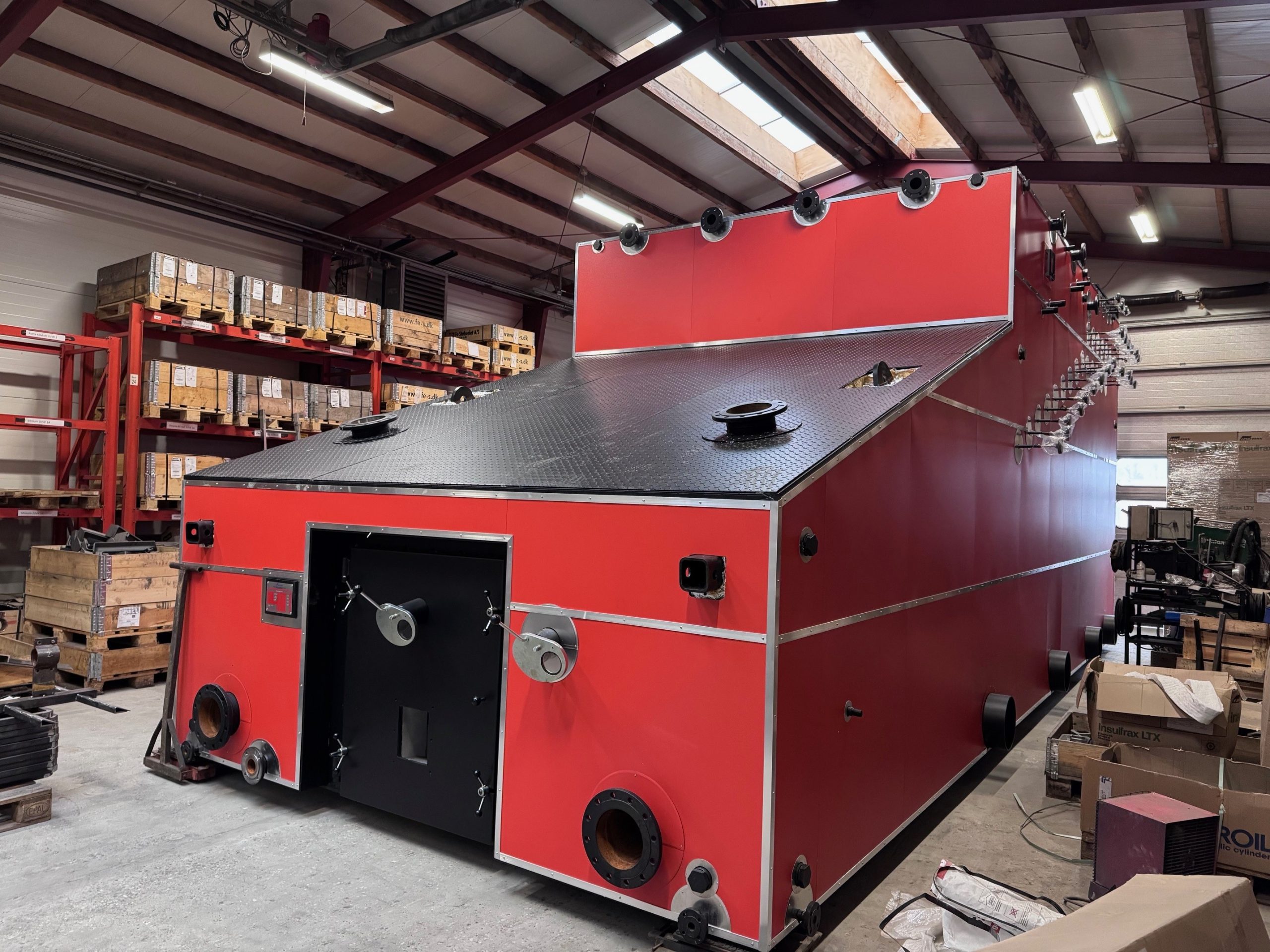 industrial chip boiler in operation, efficiently burning wood chips to supply renewable heat to a commercial or industrial building