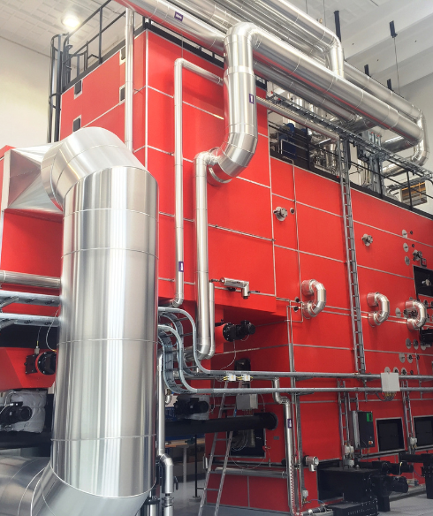Large industrial biomass boiler system designed for high-capacity heating, powered by sustainable fuels like wood chips and agricultural waste
