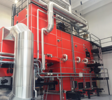 Large industrial biomass boiler system designed for high-capacity heating, powered by sustainable fuels like wood chips and agricultural waste