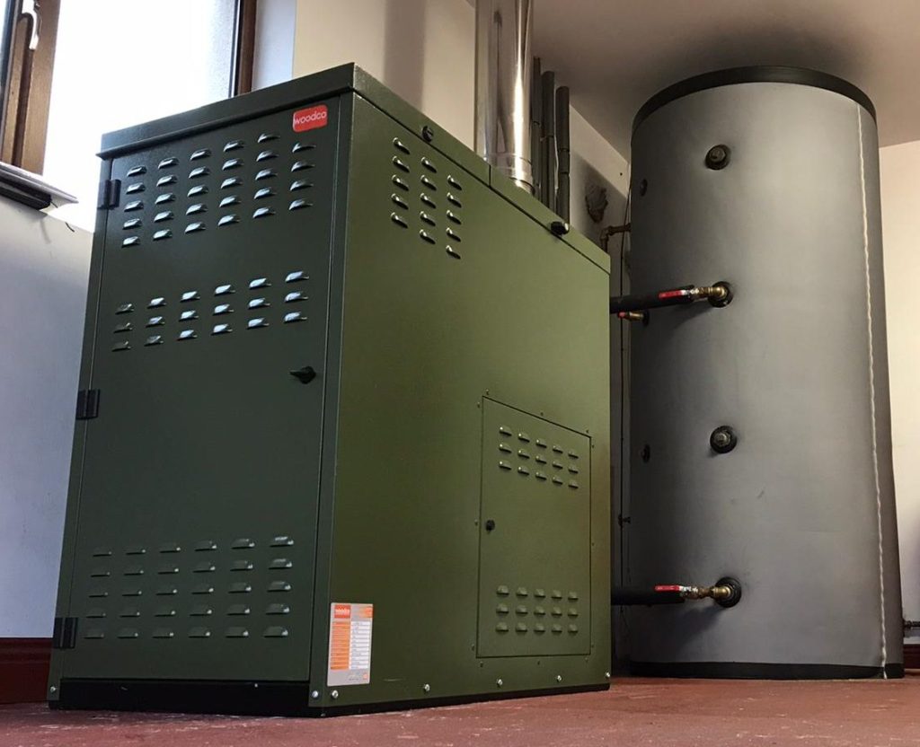 Domestic pellet boiler system installed in a home, connected to a central heating system for efficient, renewable heating.