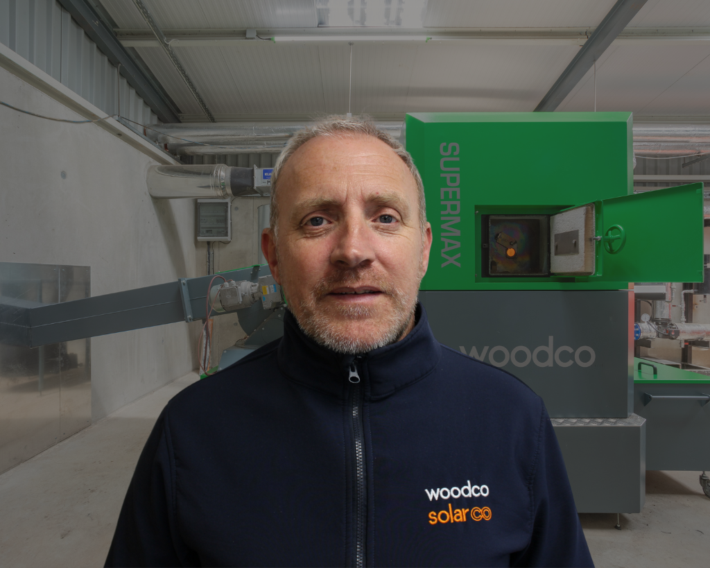 picture of a service engineer in front of a woodco biomass boiler