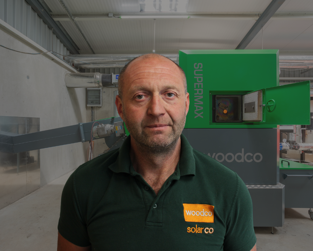 picture of a service engineer in front of a woodco biomass boiler